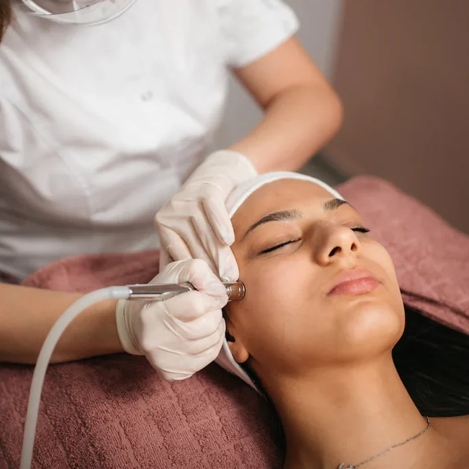 ED_Microdermabrasion a woman getting a microdermabrasion treatment on the face